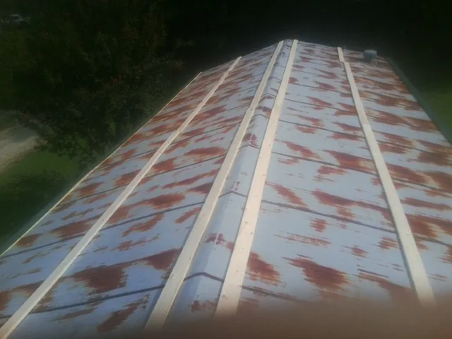 Rusted metal roof panels with new wood purlins before replacement — Storm Damage Roof Repair in Murfreesboro by Roofing Brothers