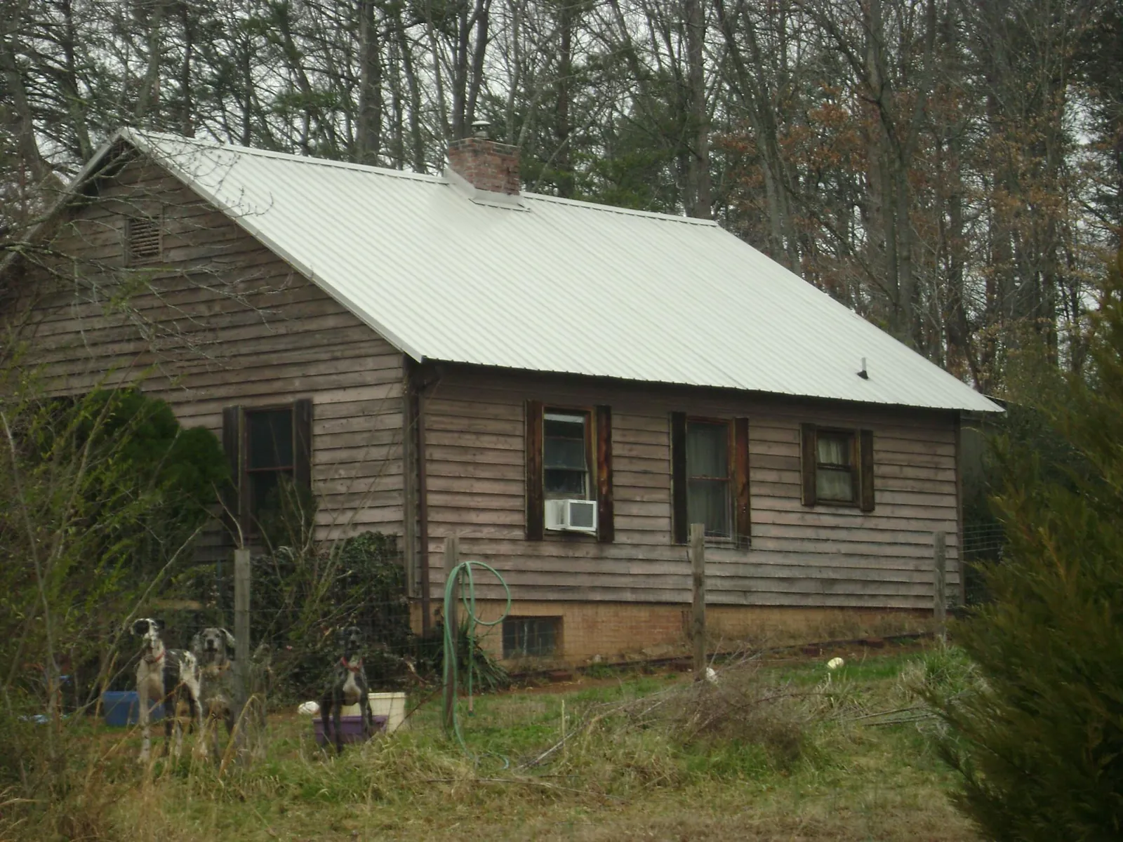 White metal roof on an old wood sided farmhouse, from a Metal Roof Installation job in Murfreesboro